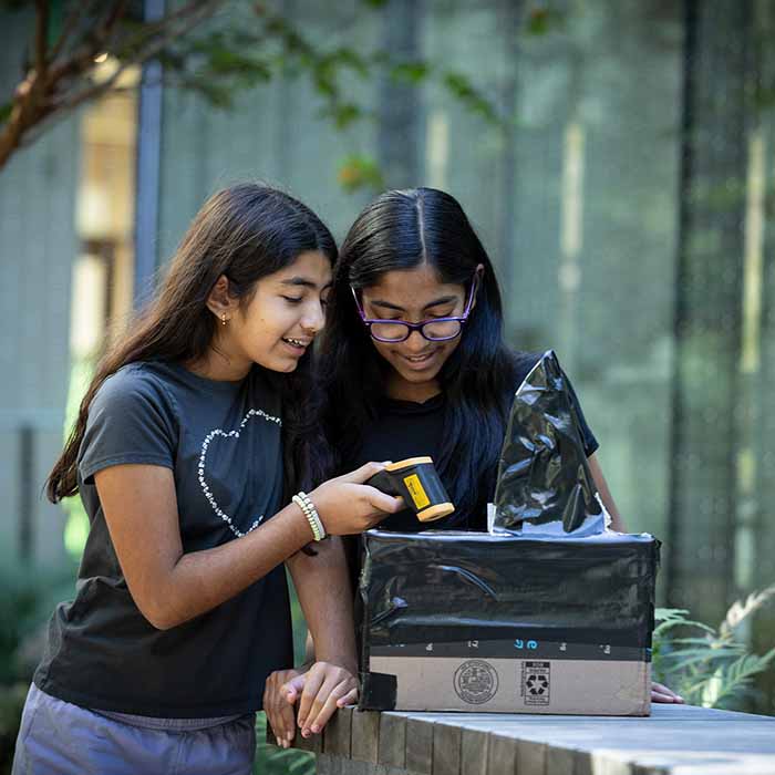 Students taking the temperature for a science experiment