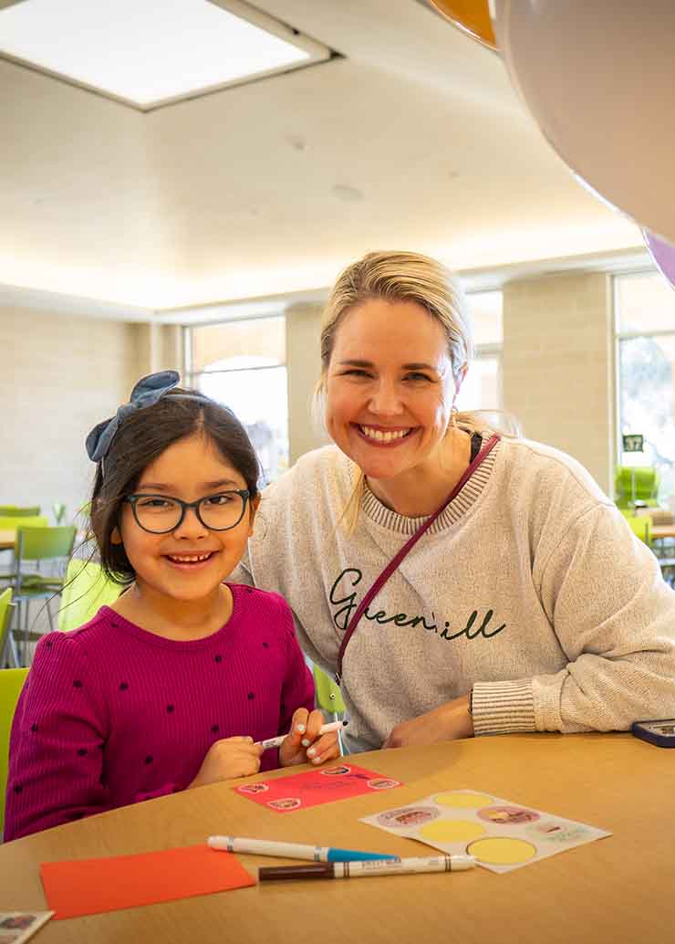 Parent volunteering with child